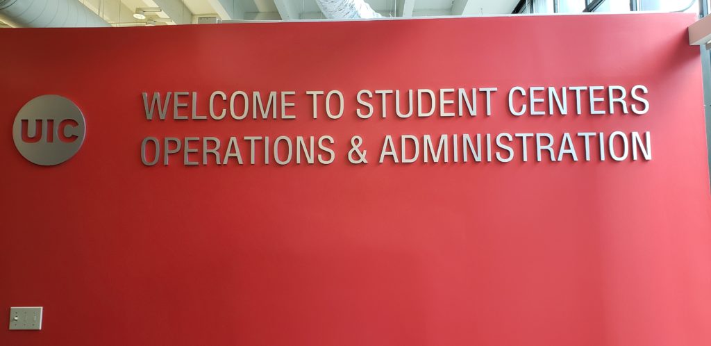 University sign on red wall